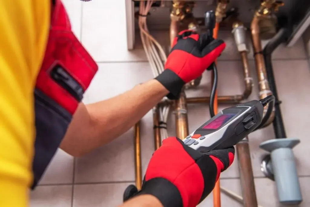 plumber inspecting gas fittings